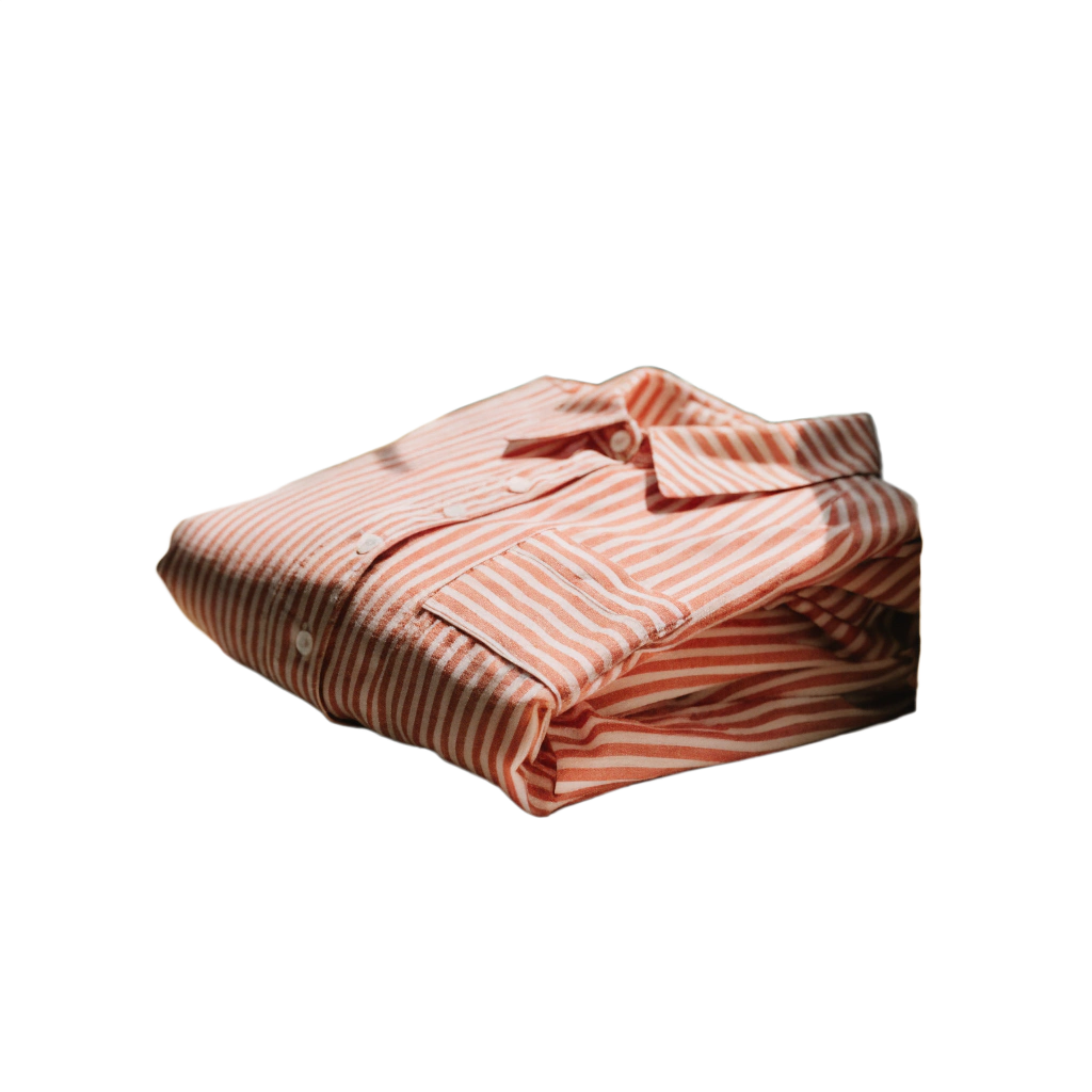 Folded pink and white striped women's pajama shirt with button-front design on a black background